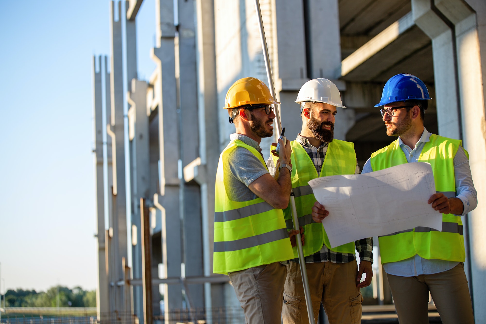 Construction engineers discussion with architects at construction or building site